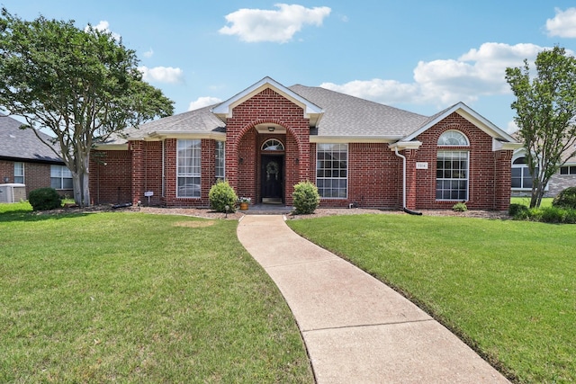 7314 Glenstone St, Rowlett, TX 75089 - view of front of home with brick siding, a front lawn, and a shingled roof