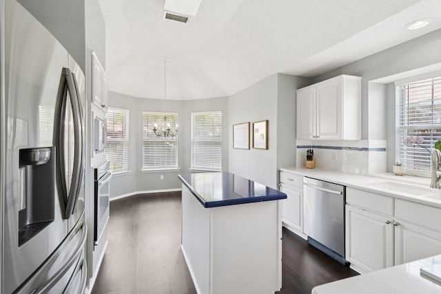7314 Glenstone St, Rowlett, TX 75089 - kitchen with stainless steel appliances, a sink, dark wood-style floors, and a chandelier