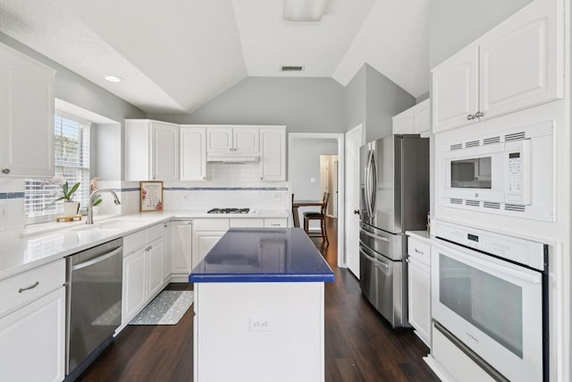 7314 Glenstone St, Rowlett, TX 75089 - kitchen with appliances with stainless steel finishes, a sink, a kitchen island, backsplash, and under cabinet range hood