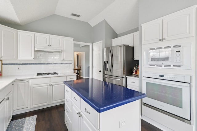 7314 Glenstone St, Rowlett, TX 75089 - kitchen featuring white appliances, under cabinet range hood, vaulted ceiling, white cabinetry, and dark wood-style floors