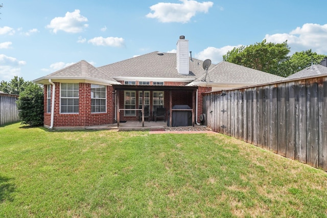 7314 Glenstone St, Rowlett, TX 75089 - back of house with a patio, brick siding, a chimney, and roof with shingles