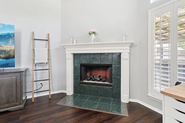 7314 Glenstone St, Rowlett, TX 75089 - detailed view of wood finished floors, a tile fireplace, and baseboards