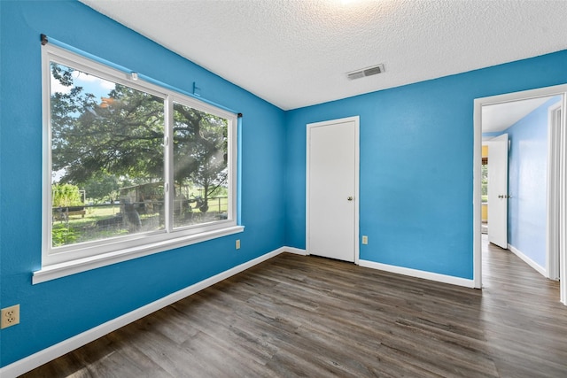 1200 Old Decatur Rd, Decatur, TX 76234 - unfurnished bedroom featuring wood finished floors, baseboards, and a textured ceiling