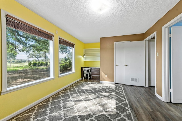 1200 Old Decatur Rd, Decatur, TX 76234 - bedroom featuring a textured ceiling, wood finished floors, baseboards, and an office area