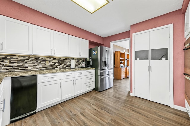 1200 Old Decatur Rd, Decatur, TX 76234 - kitchen featuring stainless steel refrigerator with ice dispenser, tasteful backsplash, and light wood-style flooring