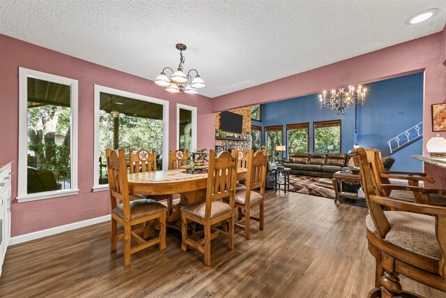 1200 Old Decatur Rd, Decatur, TX 76234 - dining area featuring a chandelier, a textured ceiling, wood finished floors, and baseboards