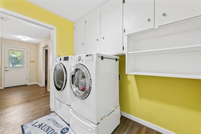 1200 Old Decatur Rd, Decatur, TX 76234 - laundry area with cabinet space, washing machine and dryer, baseboards, dark wood-type flooring, and a textured ceiling