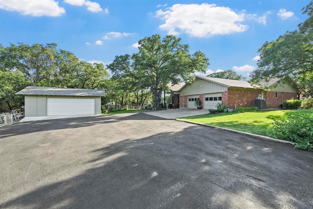 1200 Old Decatur Rd, Decatur, TX 76234 - view of front of property with a detached garage, brick siding, central AC unit, and a front lawn