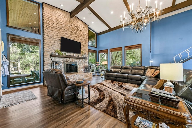 1200 Old Decatur Rd, Decatur, TX 76234 - living area with high vaulted ceiling, beam ceiling, wood finished floors, a stone fireplace, and a chandelier