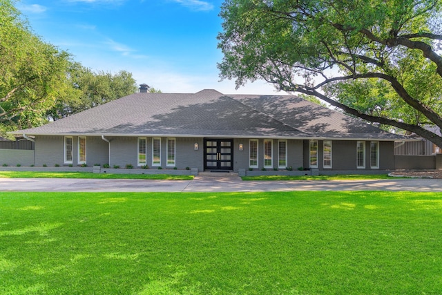 6867 Mossvine Dr, Dallas, TX 75254 - view of front of house with a front yard, roof with shingles, and brick siding