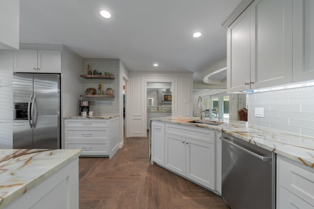 6867 Mossvine Dr, Dallas, TX 75254 - kitchen with appliances with stainless steel finishes, backsplash, open shelves, a sink, and white cabinets