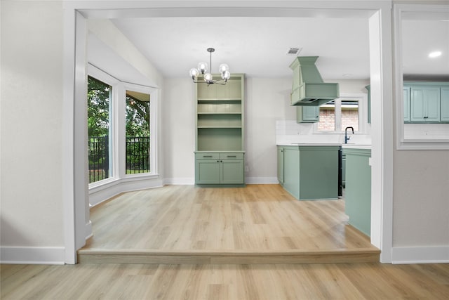5305 Links Dr, Waco, TX 76708 - unfurnished dining area featuring light wood-type flooring, baseboards, a chandelier, and a sink