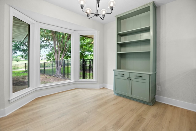 5305 Links Dr, Waco, TX 76708 - unfurnished dining area with light wood-style floors, a chandelier, and baseboards