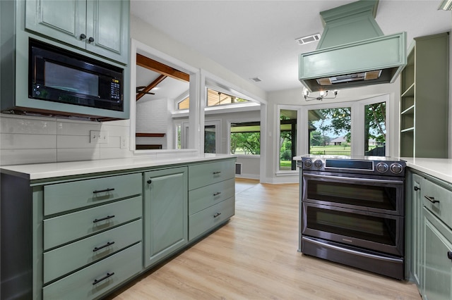 5305 Links Dr, Waco, TX 76708 - kitchen featuring green cabinets, double oven range, black microwave, and light countertops