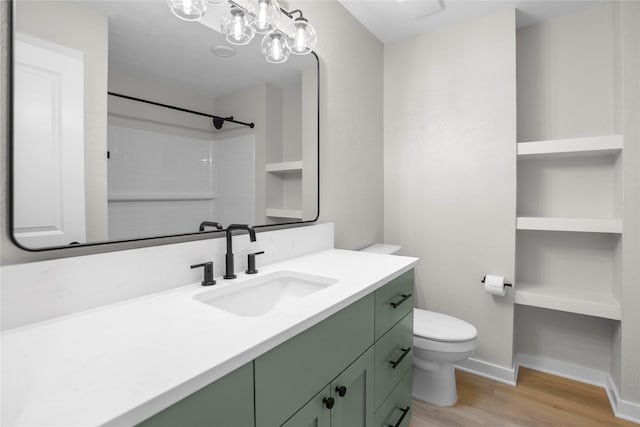 5305 Links Dr, Waco, TX 76708 - bathroom with wood finished floors, vanity, toilet, a shower, and baseboards
