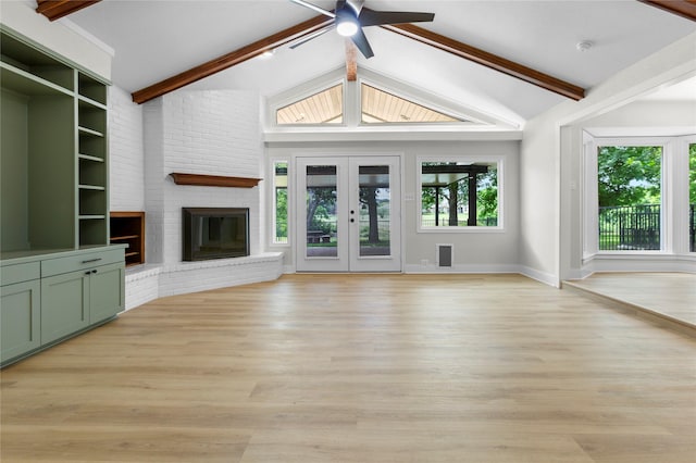 5305 Links Dr, Waco, TX 76708 - unfurnished living room featuring light wood-style floors, a ceiling fan, baseboards, french doors, and a brick fireplace