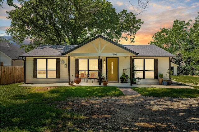 201 W Tinsley Dr, Robinson, TX 76706 - back of property at dusk featuring a shingled roof and a porch