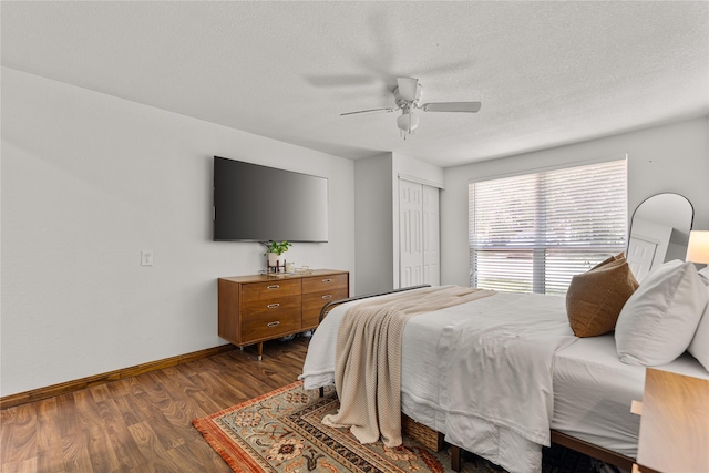 201 W Tinsley Dr, Robinson, TX 76706 - bedroom with dark wood-type flooring, baseboards, a closet, a ceiling fan, and a textured ceiling