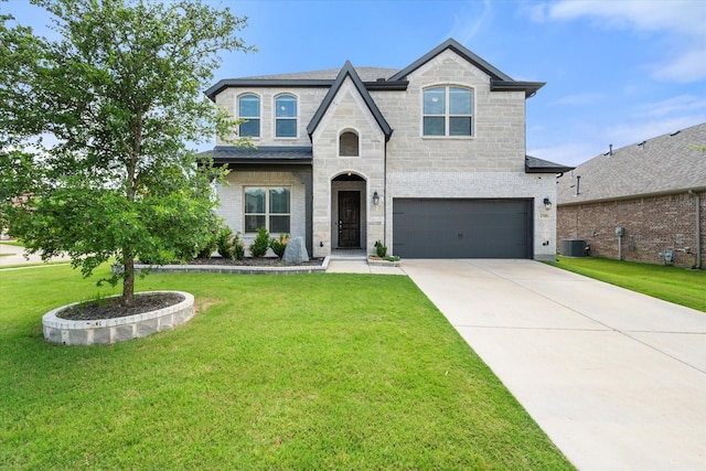 2705 Avondale Dr, Mansfield, TX 76063 - french country home featuring an attached garage, driveway, central air condition unit, and a front lawn