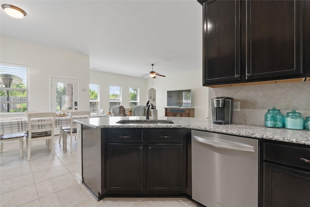 2014 Autumn Dr, Glenn Heights, TX 75154 - kitchen with stainless steel dishwasher, a peninsula, backsplash, light stone counters, and open floor plan