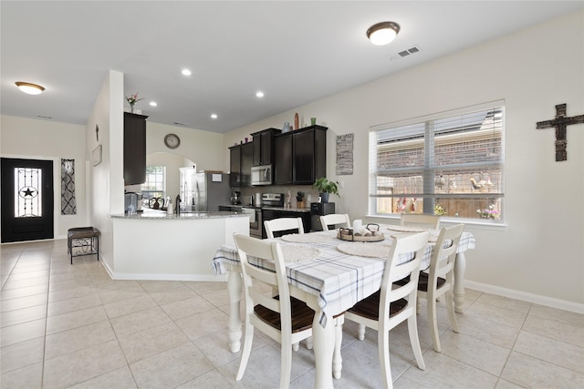 2014 Autumn Dr, Glenn Heights, TX 75154 - dining room with light tile patterned floors, arched walkways, and recessed lighting