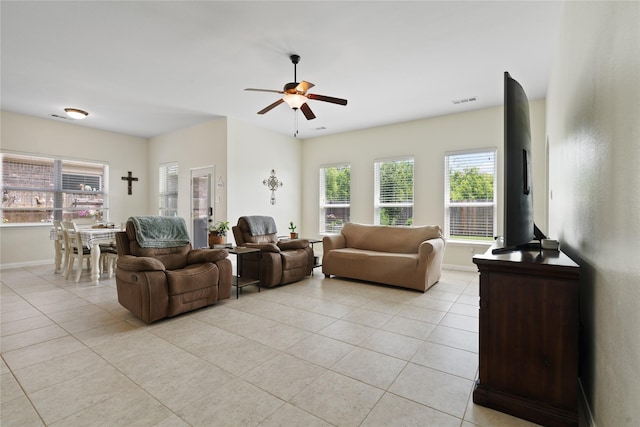 2014 Autumn Dr, Glenn Heights, TX 75154 - living area with light tile patterned floors, ceiling fan, and plenty of natural light