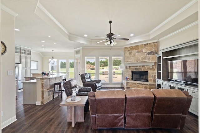 7030 Brooke Blvd, Midlothian, TX 76065 - living room featuring a raised ceiling, crown molding, a ceiling fan, plenty of natural light, and dark wood finished floors