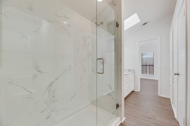 2018 Hearthside Ln, Garland, TX 75044 - full bathroom with a marble finish shower, vanity, lofted ceiling, wood finished floors, and a skylight