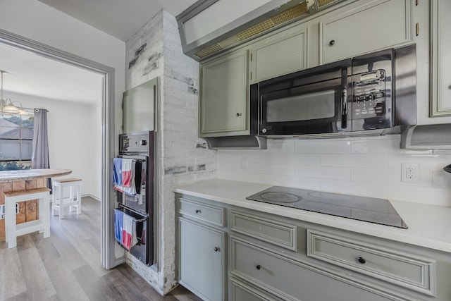 4612 Applewood Rd, Fort Worth, TX 76133 - kitchen with black appliances, a warming drawer, decorative backsplash, light countertops, and wood finished floors