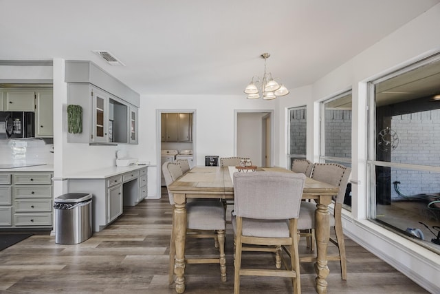 4612 Applewood Rd, Fort Worth, TX 76133 - dining room with separate washer and dryer, a chandelier, and dark wood-style floors