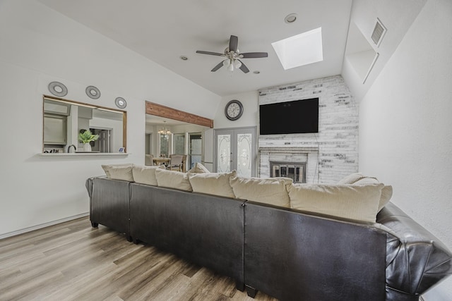 4612 Applewood Rd, Fort Worth, TX 76133 - living area featuring ceiling fan, wood finished floors, a skylight, a fireplace, and french doors