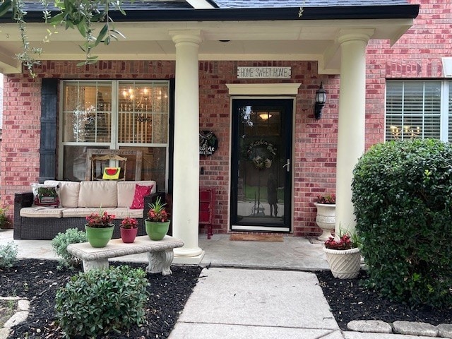 11808 Warbler Ln, Fort Worth, TX 76244 - property entrance featuring brick siding, a porch, and an outdoor hangout area