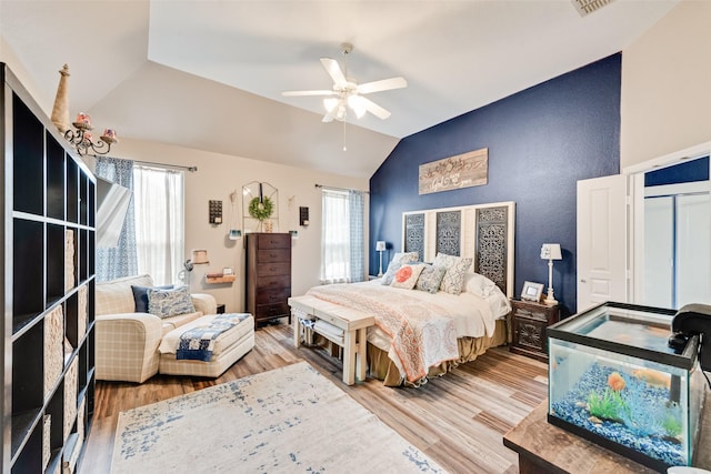11808 Warbler Ln, Fort Worth, TX 76244 - bedroom featuring lofted ceiling, multiple windows, wood finished floors, and a ceiling fan