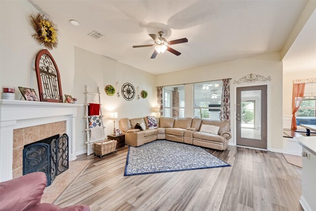 11808 Warbler Ln, Fort Worth, TX 76244 - living room featuring ceiling fan, wood finished floors, a tiled fireplace, and baseboards