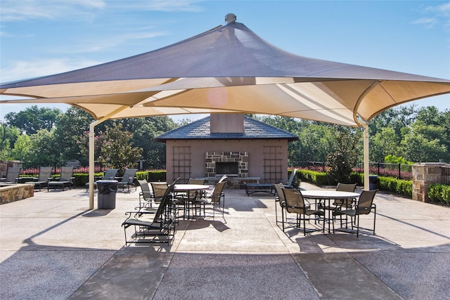 2220 Shakespeare St, Carrollton, TX 75010 - view of patio with an outdoor stone fireplace
