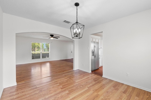 1800 Summer Glen Ct, Allen, TX 75002 - unfurnished room with arched walkways, a ceiling fan, light wood-style flooring, a chandelier, and baseboards