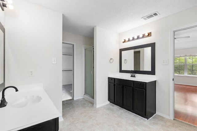 1800 Summer Glen Ct, Allen, TX 75002 - bathroom with two vanities, a shower stall, a textured ceiling, and baseboards