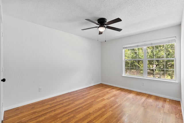 1800 Summer Glen Ct, Allen, TX 75002 - empty room with wood finished floors, ceiling fan, a textured ceiling, and baseboards