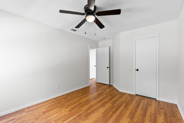1800 Summer Glen Ct, Allen, TX 75002 - unfurnished bedroom with light wood-style flooring, baseboards, a textured ceiling, and ceiling fan