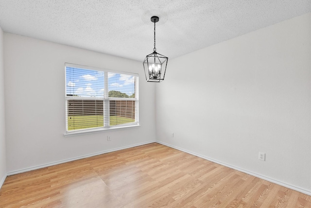 1800 Summer Glen Ct, Allen, TX 75002 - unfurnished room featuring a chandelier, wood finished floors, a textured ceiling, and baseboards