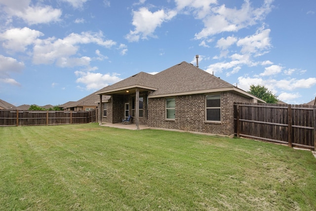 269 Arbury Dr, Forney, TX 75126 - back of property featuring brick siding, a patio, roof with shingles, and a fenced backyard