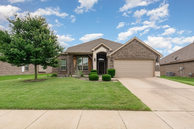 269 Arbury Dr, Forney, TX 75126 - view of front of house with brick siding, an attached garage, concrete driveway, a front lawn, and a shingled roof