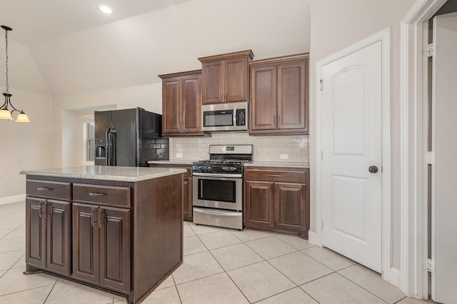 269 Arbury Dr, Forney, TX 75126 - kitchen featuring stainless steel appliances, light tile patterned floors, vaulted ceiling, backsplash, and a kitchen island