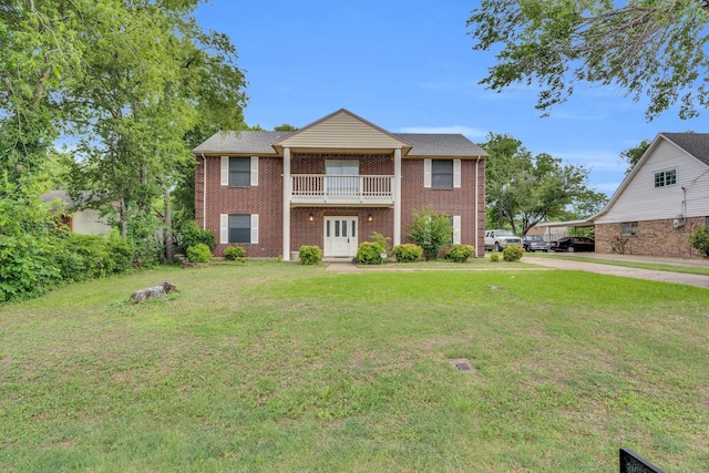 1211 Plateau Dr, Duncanville, TX 75116 - greek revival inspired property with a balcony, a front lawn, concrete driveway, and brick siding