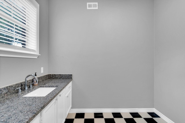 1211 Plateau Dr, Duncanville, TX 75116 - bathroom featuring tile patterned floors, baseboards, and vanity