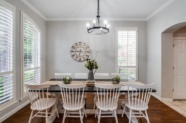 439 Fox Trl, Allen, TX 75002 - tiled dining space featuring arched walkways, a chandelier, and crown molding