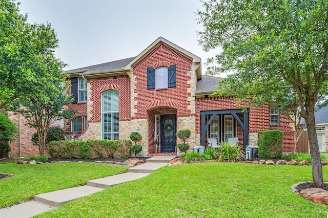 439 Fox Trl, Allen, TX 75002 - view of front of home featuring brick siding, a front yard, stone siding, and a shingled roof