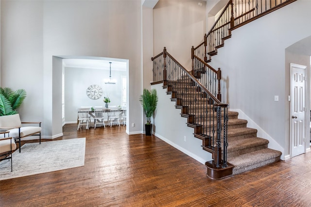 439 Fox Trl, Allen, TX 75002 - entryway featuring a high ceiling, stairway, wood finished floors, baseboards, and arched walkways