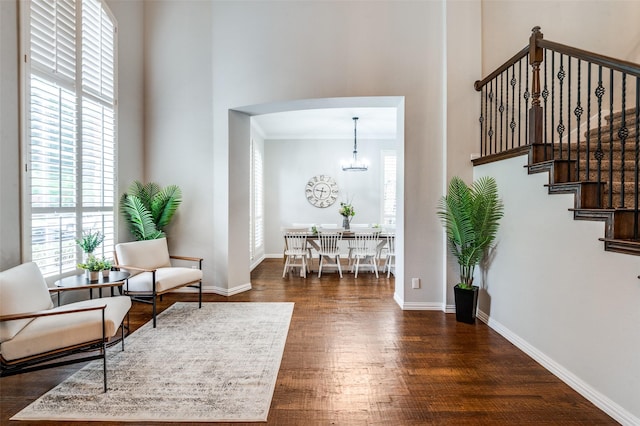 439 Fox Trl, Allen, TX 75002 - sitting room featuring a chandelier, wood finished floors, arched walkways, baseboards, and ornamental molding