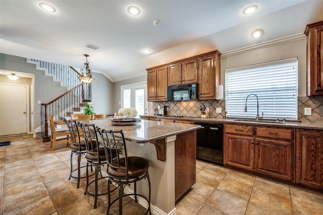 417 Fox Trl, Allen, TX 75002 - kitchen featuring black appliances, a sink, vaulted ceiling, decorative backsplash, and a breakfast bar area